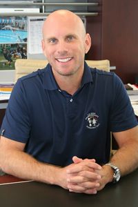 A photo of Craig Stein, McNICHOLS CFO and Senior VP, smiling at his desk.