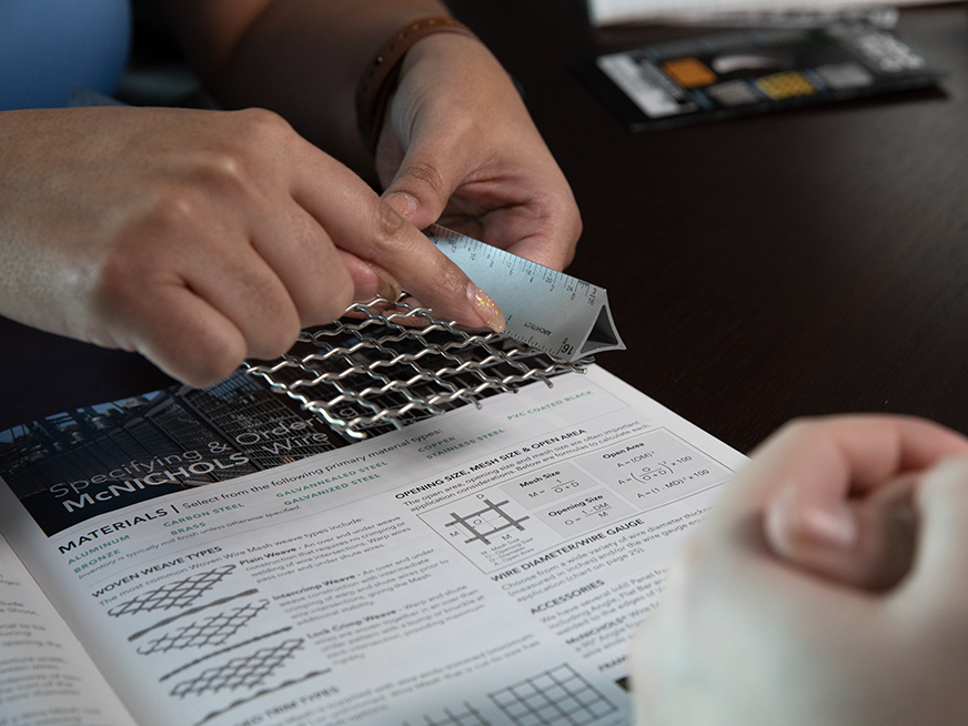 A photo of a person measuring the open area of a Wire Mesh sample.