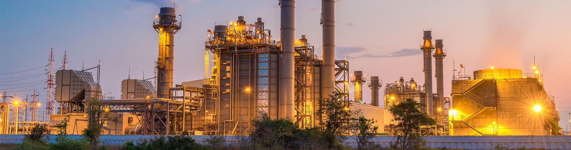 A wide shot of an energy power plant at sunset.