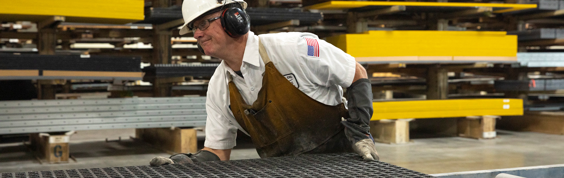 An operations associate moving Fiberglass Grating so it can be cut-to-size.