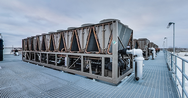 A rooftop cooling system on top of a data center, supported by Bar Grating.